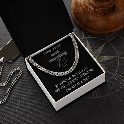 Silver-tone chain necklace displayed in a white gift box
