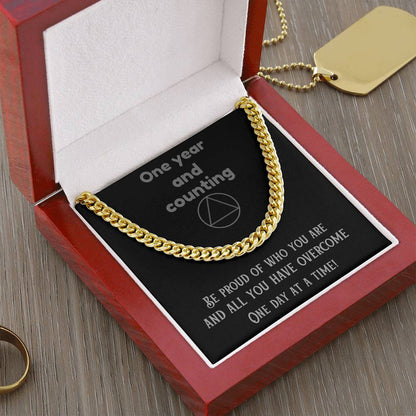 Gold-tone curb-link chain necklace on a jewelry insert in a box