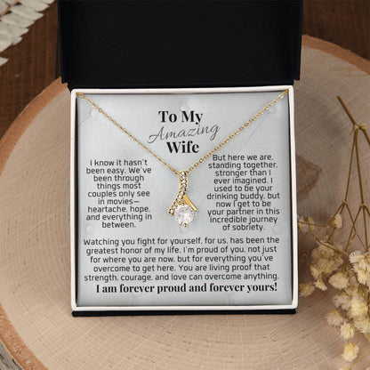 Gold-tone pendant necklace in gift box, teardrop charm with clear stones and chain