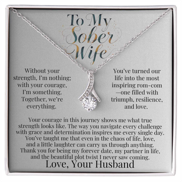 Silver-tone teardrop pendant necklace with faceted stone on a chain