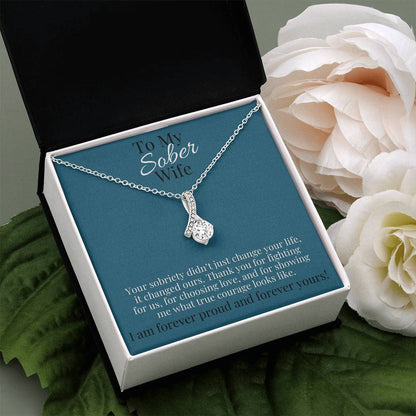 Silver-toned teardrop pendant necklace on a chain with small pave stones.