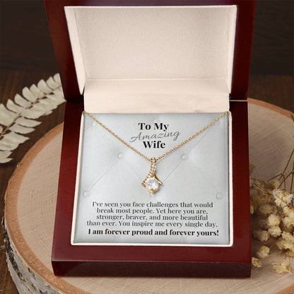 Open gift box with gold-tone necklace and teardrop pendant, message card