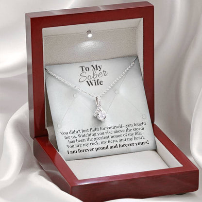 Silver-tone teardrop pendant necklace in red gift box, on chain.