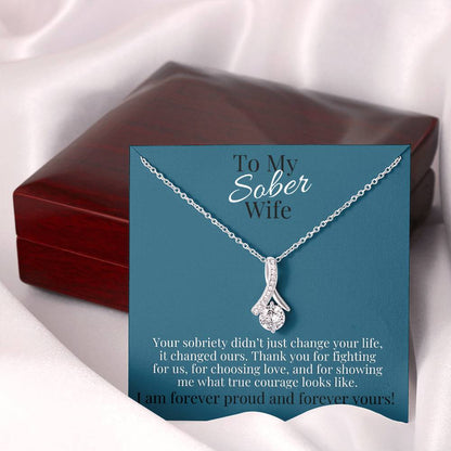 Silver-toned teardrop pendant necklace on a chain in a gift box.