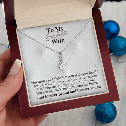 Silver-tone teardrop pendant necklace in red gift box on chain.