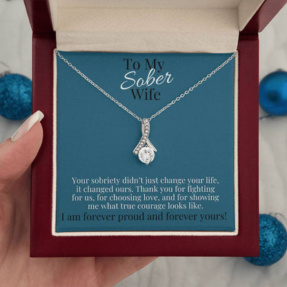 Silver-toned necklace with teardrop pendant and small pave stones on a chain.