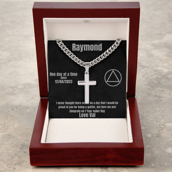 Silver cross pendant necklace on black card inside red wooden gift box