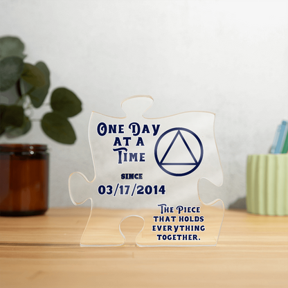 Clear acrylic puzzle display with blue quote text and triangle emblem with jigsaw edges