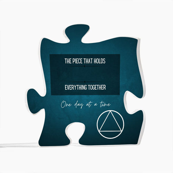 Teal puzzle-piece sign with uplifting quote and outline triangle graphic