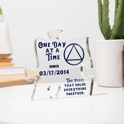 Clear acrylic puzzle display with blue quote text, triangle emblem, and metal-like edges
