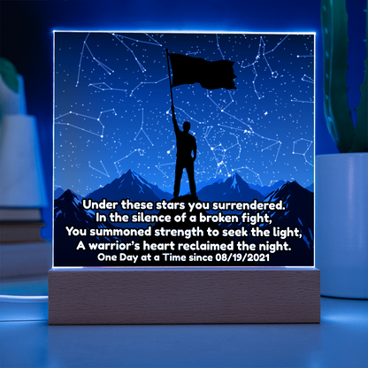 LED star map panel glowing blue with constellation lines, flag silhouette and figure