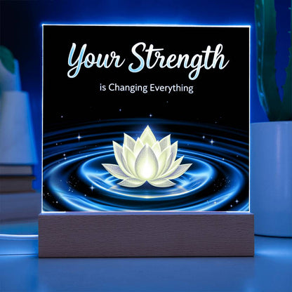LED strength plaque with “Your Strength” and glowing lotus in blue ring, on wood base