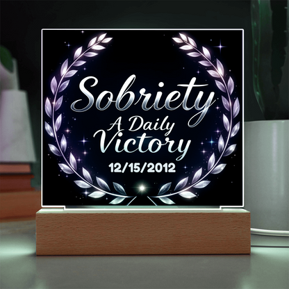 Square LED plaque on wood base with laurel wreath, “Sobriety A Daily Victory” and 12/15/2012.