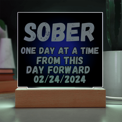 SOBER LED square plaque with white-lit border, blue text, and light-wood base