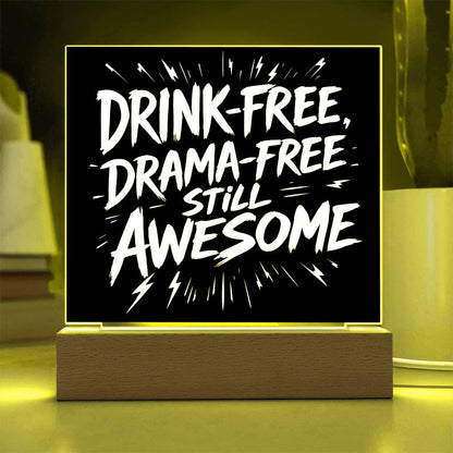 LED plaque with black panel and white slogan DRINK-FREE, DRAMA-FREE, STILL AWESOME, yellow-lit frame