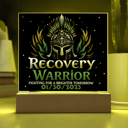 Square acrylic LED plaque on wood base, black front with teal title, yellow-lit frame border