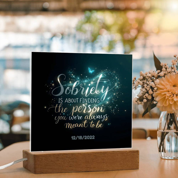 LED sobriety plaque with glowing blue text on black panel, butterflies, wooden base