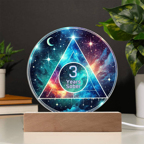 LED galaxy sobriety plaque with 3 Years Sober text on a circular panel, on a wood base