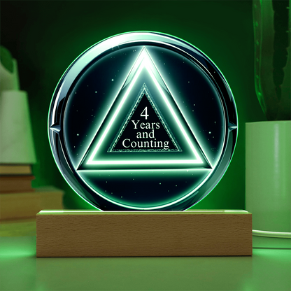 LED circle plaque with “4 Years and Counting” on wood base, green glow