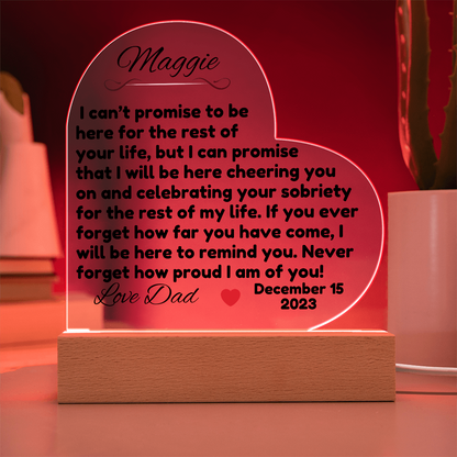 Acrylic LED heart sign with Maggie message, red glow outline on wooden base
