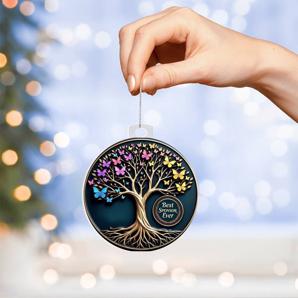 Acrylic tree ornament with colorful butterflies and hanging loop, held by hand