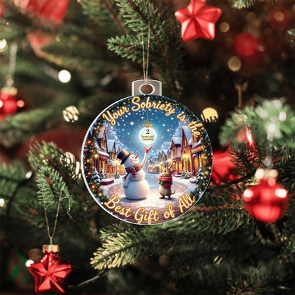 Hanging circular acrylic bulb ornament with snowman winter scene and gold 'Sobriety' text