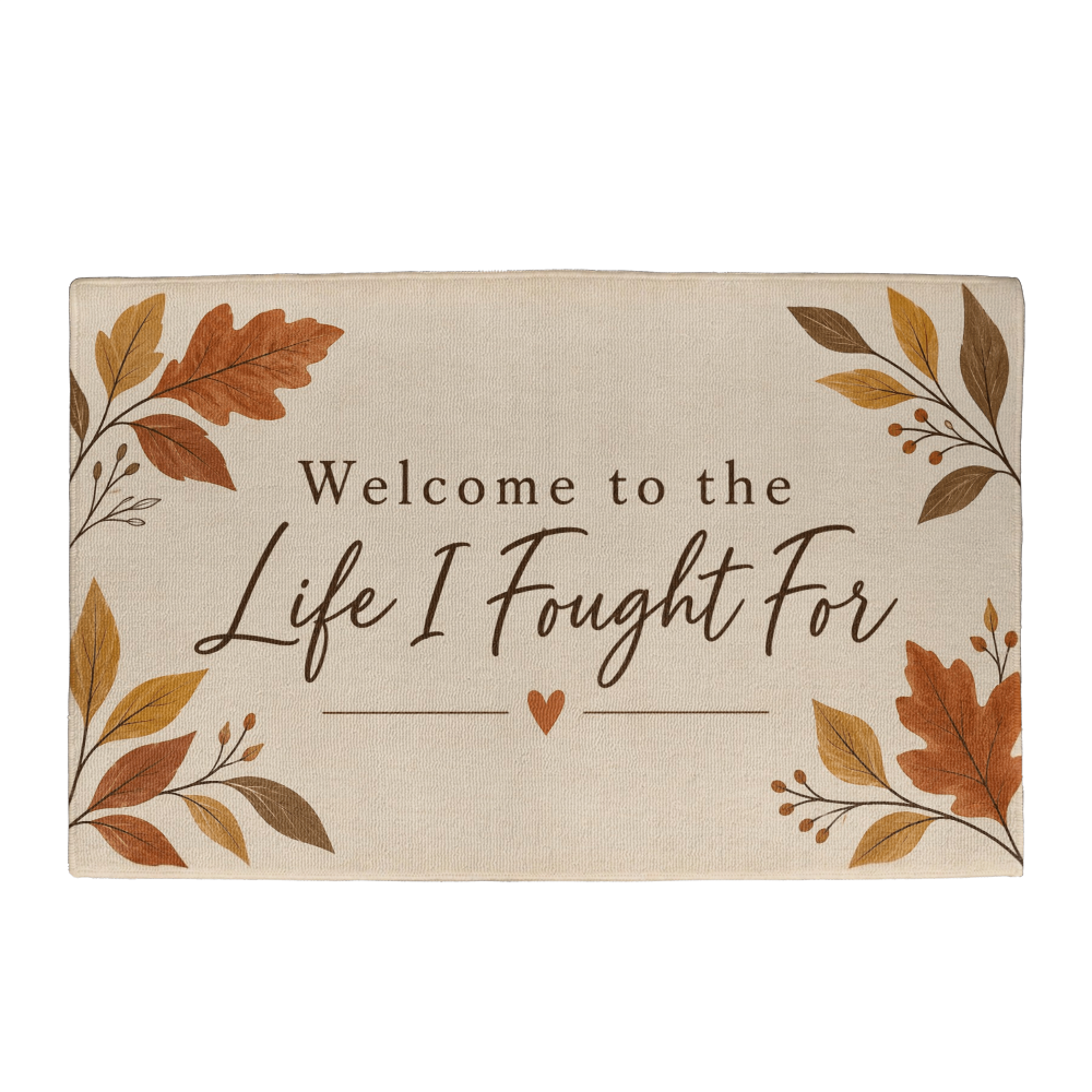 Beige welcome mat with autumn leaves and text "Welcome to the Life I Fought For"