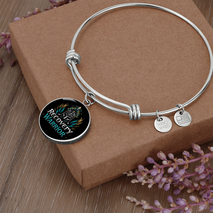 Silver bangle bracelet with round warrior emblem charm and small USA-made tags