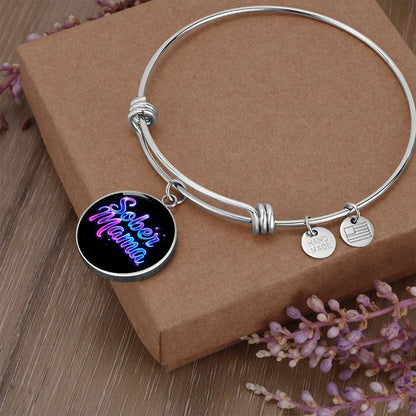 Silver bangle bracelet with “Sober Mama” round charm and small metal tags