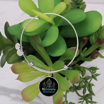 Silver bangle bracelet with round warrior emblem medallion and hinge clasp