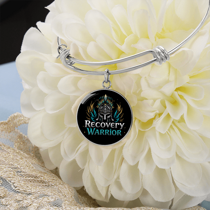 Silver bangle bracelet with round warrior emblem charm and twisted knot detail