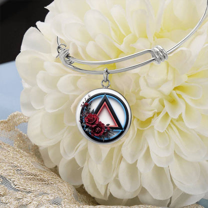 Silver bangle bracelet with round recovery symbol charm and red rose detail
