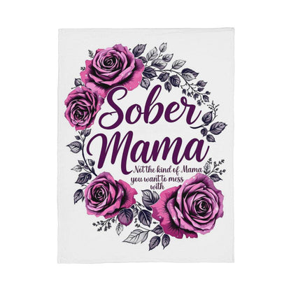 White blanket featuring a purple rose wreath and large “Sober Mama” script in the middle.