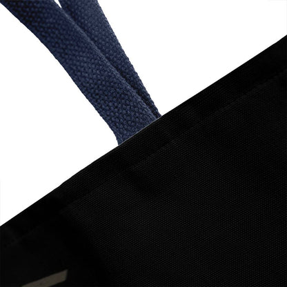 Black Halloween tote bag with navy woven handle strap and textured fabric close-up
