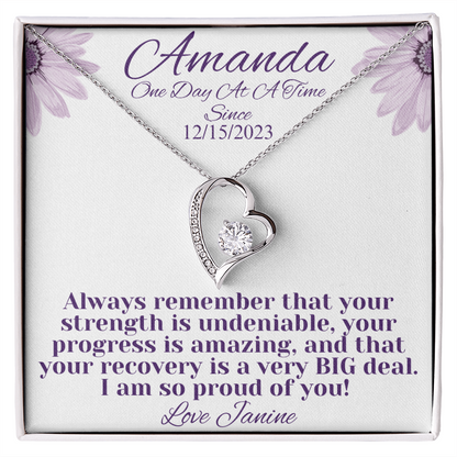 Silver heart recovery necklace with diamond-like center and side stones, chain included