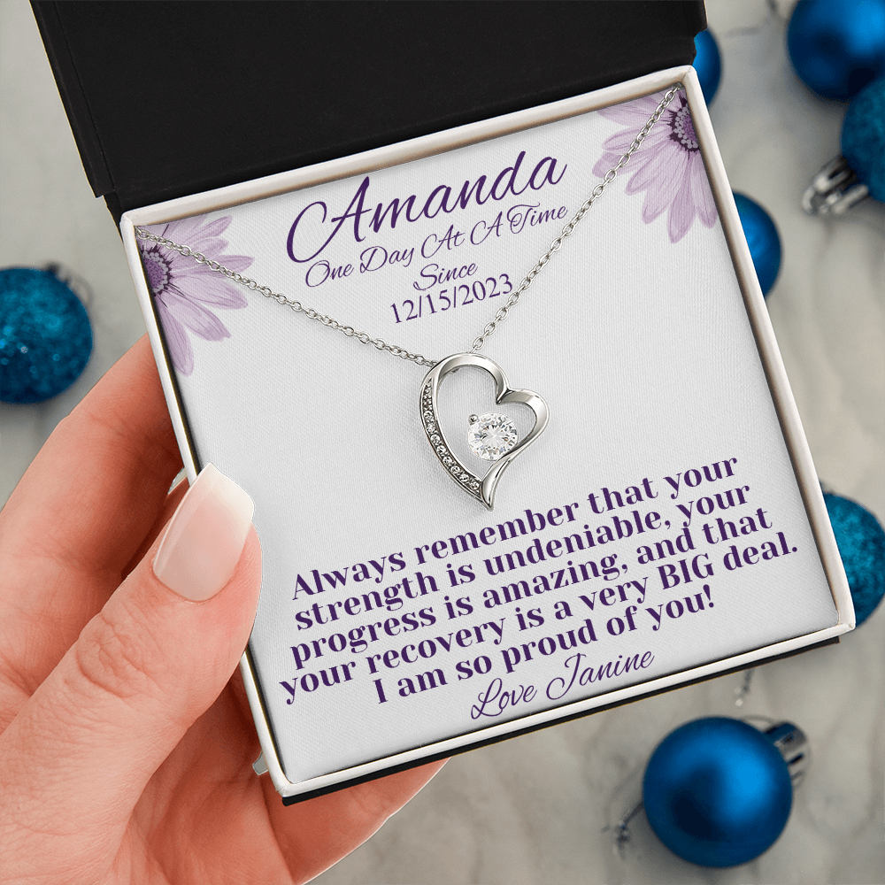 Silver heart recovery necklace with crystal-studded heart pendant, held in gift box