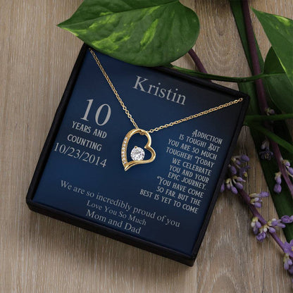 Gold heart pendant necklace in gift box, with 10 years and date 10/23/2014 on card