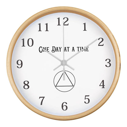 Natural wood round wall clock with “One Day At A Time” text, black numbers, and hands