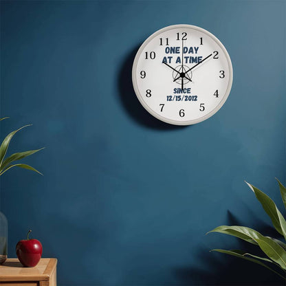 White wall clock with black numerals and blue “SINCE 12/15/2012” centered on face