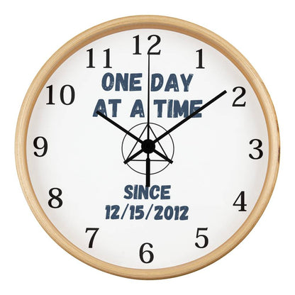 Natural wood wall clock close-up with black numerals and blue “SINCE 12/15/2012”