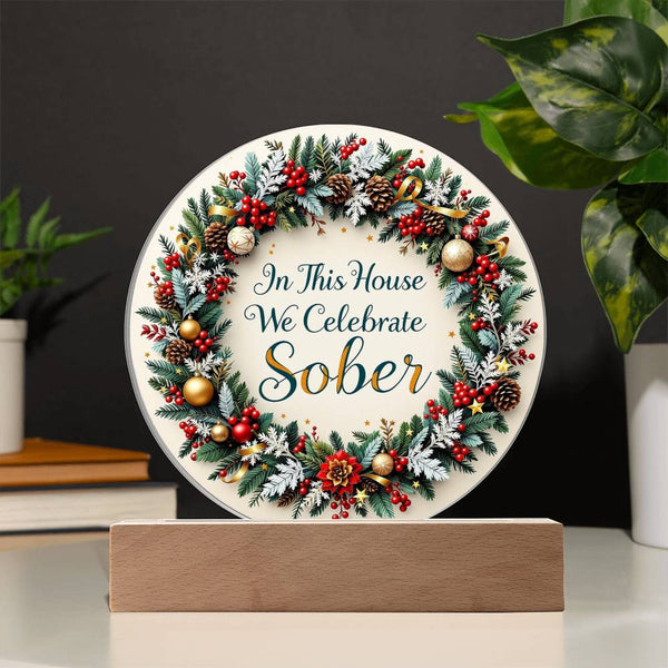 LED acrylic holiday wreath plaque on wood base: 'In This House We Celebrate Sober'