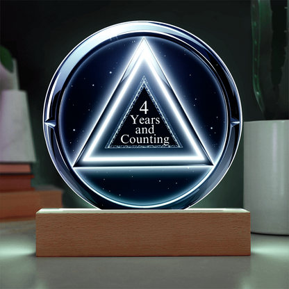 LED circle plaque with “4 Years and Counting” on wood base, blue-white glow