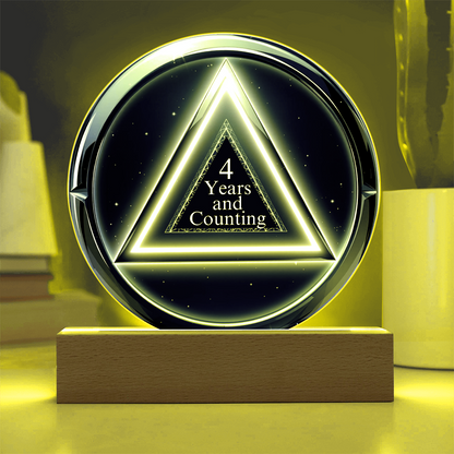 LED circle plaque with “4 Years and Counting” on wood base, yellow glow
