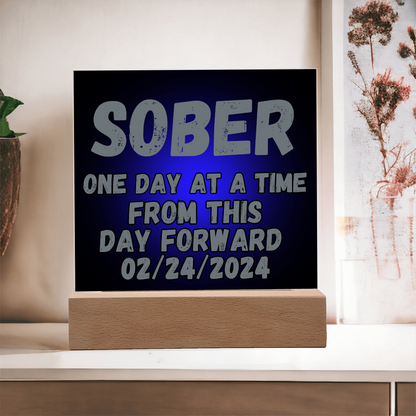 SOBER LED square plaque with blue text on dark panel and light-wood base