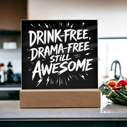 LED plaque with black panel and white slogan DRINK-FREE, DRAMA-FREE, STILL AWESOME on wood base