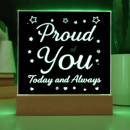 LED message plaque with green light outline and glowing “Proud of You” text on wood base
