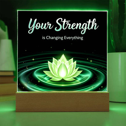 LED strength plaque with “Your Strength” and glowing lotus in green ring, on wood base