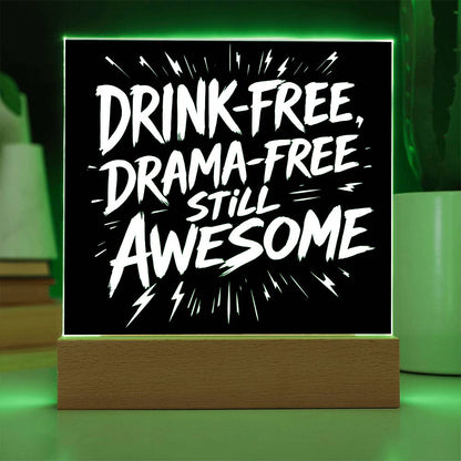 LED plaque with black panel and white slogan DRINK-FREE, DRAMA-FREE, STILL AWESOME, green-lit frame
