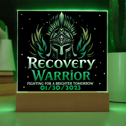 Square acrylic LED plaque on wood base, black front with teal text, green-lit frame border
