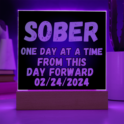 SOBER LED square plaque with purple-lit border, blue text, and dark base